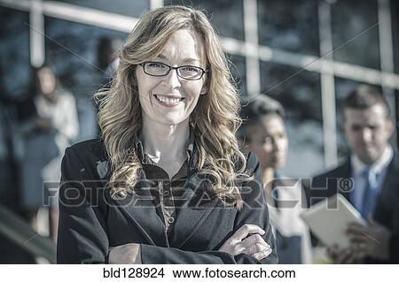 Picture - Businesswoman smiling outdoors. Fotosearch