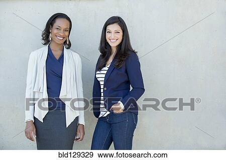 Stock Photo - Businesswomen smiling together. Fotosearch