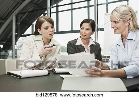 Businesswomen talking in meeting View Large Photo Image Stock Photo - Businesswomen talking in meeting. Fotosearch