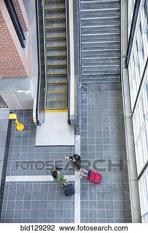 Businesswomen talking near stairs and escalator View Large Photo Image Stock Image - Businesswomen talking near stairs and escalator. Fotosearch