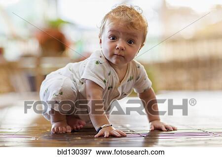 Caucasian baby crawling on floor View Large Photo Image Stock Photo - Caucasian baby crawling on floor. Fotosearch