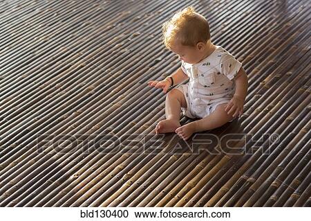 Caucasian baby playing on bamboo floor View Large Photo Image Stock Image - Caucasian baby playing on bamboo floor. Fotosearch
