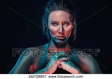 Stock Photo - Caucasian boxer cracking her knuckles. Fotosearch