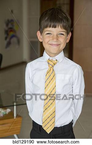 Stock Image - Caucasian boy smiling in formal wear. Fotosearch