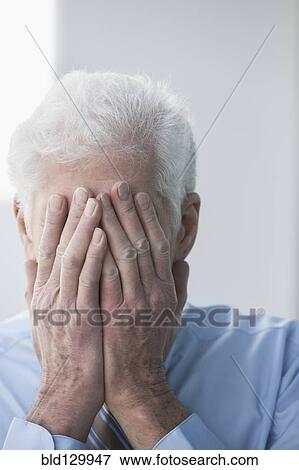Caucasian businessman covering his face View Large Photo Image Stock Photo - Caucasian businessman covering his face. Fotosearch