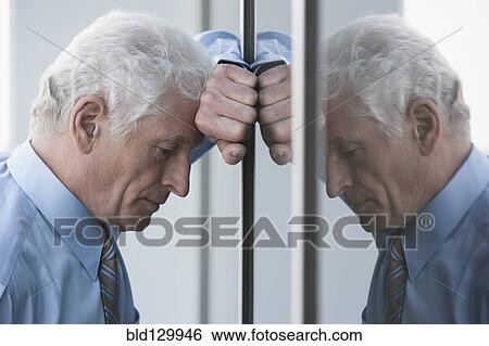 Caucasian businessman leaning on window View Large Photo Image Stock Photograph - Caucasian businessman leaning on window. Fotosearch
