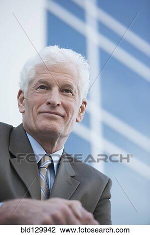 Stock Image - Caucasian businessman outdoors. Fotosearch