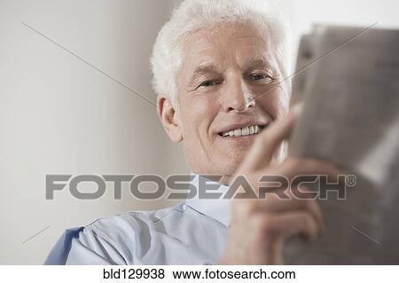 Caucasian businessman reading newspaper View Large Photo Image Stock Photo - Caucasian businessman reading newspaper. Fotosearch