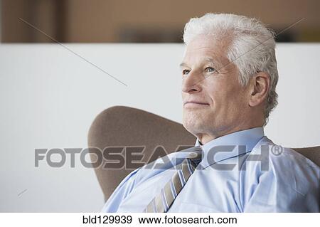 Caucasian businessman sitting in office View Large Photo Image Stock Photo - Caucasian businessman sitting in office. Fotosearch