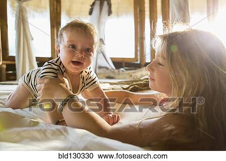 Caucasian children playing on bed View Large Photo Image Stock Image - Caucasian children playing on bed. Fotosearch