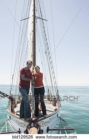 Caucasian couple on sailboat View Large Photo Image Stock Photograph - Caucasian couple on sailboat. Fotosearch
