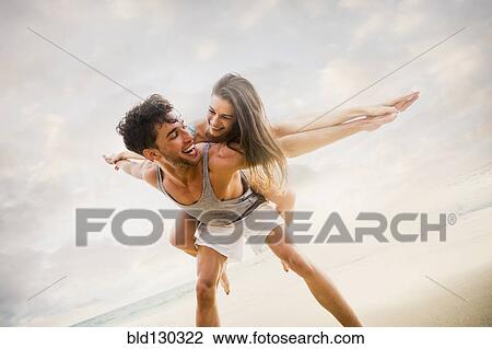 Caucasian couple playing on beach View Large Photo Image Stock Image - Caucasian couple playing on beach. Fotosearch