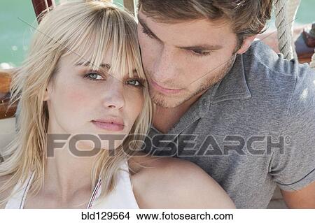 Caucasian couple relaxing on sailboat View Large Photo Image Picture - Caucasian couple relaxing on sailboat. Fotosearch