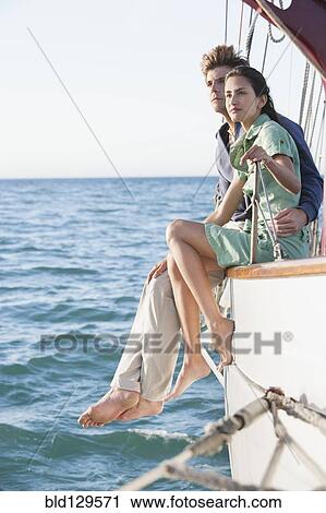 Caucasian couple relaxing on sailboat View Large Photo Image Stock Image - Caucasian couple relaxing on sailboat. Fotosearch