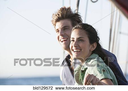 Caucasian couple relaxing on sailboat View Large Photo Image Stock Image - Caucasian couple relaxing on sailboat. Fotosearch