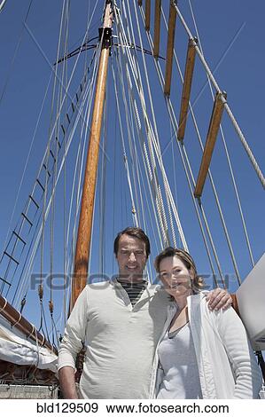 Caucasian couple smiling on sailboat View Large Photo Image Stock Photo - Caucasian couple smiling on sailboat. Fotosearch