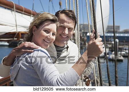 Caucasian couple smiling on sailboat View Large Photo Image Stock Photography - Caucasian couple smiling on sailboat. Fotosearch