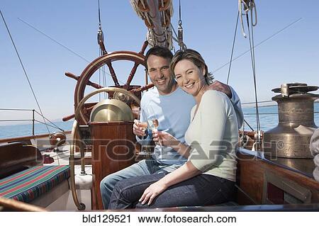 Caucasian couple toasting each other on sailboat View Large Photo Image Stock Image - Caucasian couple toasting each other on sailboat. Fotosearch