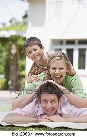 Caucasian family relaxing in backyard View Large Photo Image Stock Photo - Caucasian family relaxing in backyard. Fotosearch