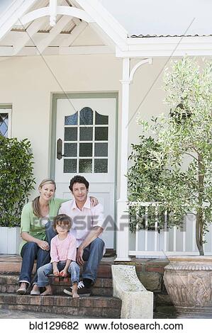 Caucasian family smiling on front steps View Large Photo Image Stock Image - Caucasian family smiling on front steps. Fotosearch