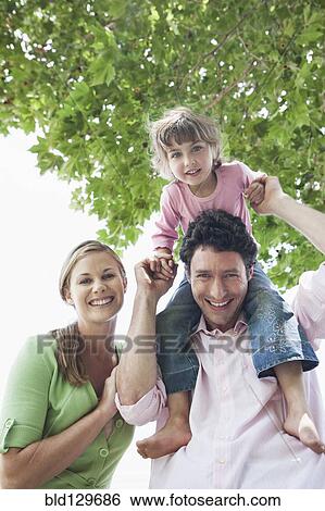 Caucasian family smiling outdoors View Large Photo Image Stock Photograph - Caucasian family smiling outdoors. Fotosearch