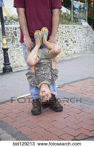 Caucasian father and son playing on city street View Large Photo Image Stock Image - Caucasian father and son playing on city street. Fotosearch