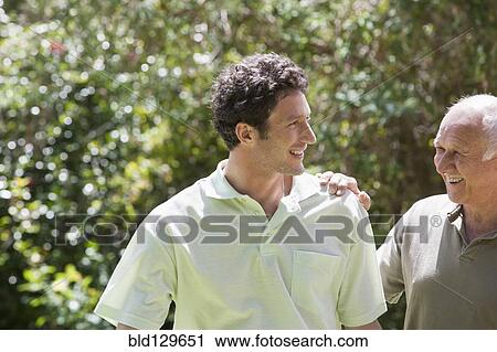 Caucasian father and son walking in park View Large Photo Image Stock Image - Caucasian father and son walking in park. Fotosearch