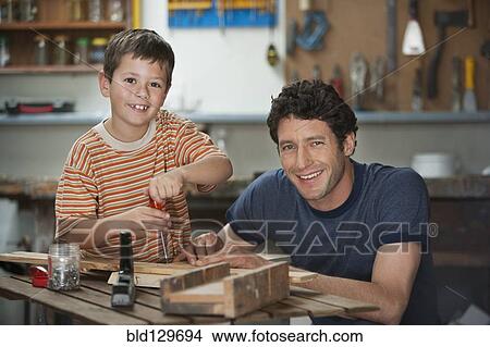 Caucasian father and son working in woodshop View Large Photo Image Picture - Caucasian father and son working in woodshop. Fotosearch