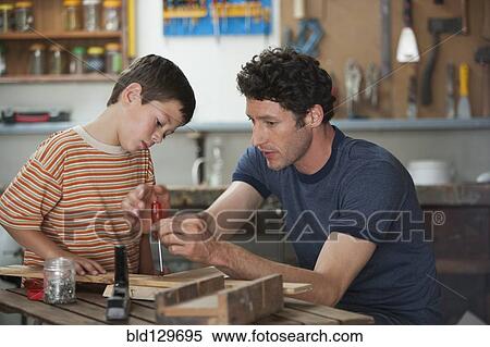 Caucasian father and son working in woodshop View Large Photo Image Stock Photography - Caucasian father and son working in woodshop. Fotosearch