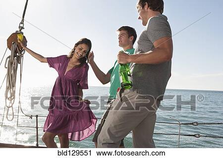 Caucasian friends celebrating on sailboat View Large Photo Image Stock Image - Caucasian friends celebrating on sailboat. Fotosearch