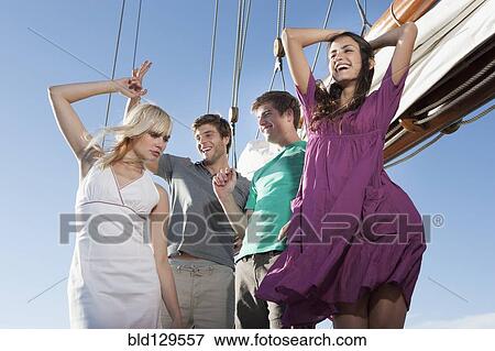 Caucasian friends dancing on sailboat View Large Photo Image Stock Photo - Caucasian friends dancing on sailboat. Fotosearch