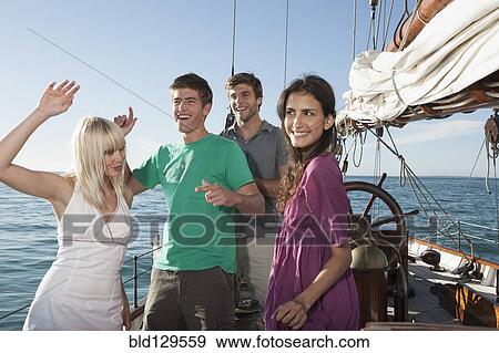 Caucasian friends dancing on sailboat View Large Photo Image Stock Photo - Caucasian friends dancing on sailboat. Fotosearch