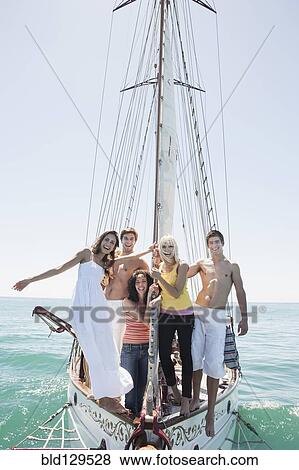 Caucasian friends on sailboat View Large Photo Image Stock Photo - Caucasian friends on sailboat. Fotosearch