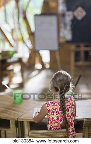 Caucasian girl painting at desk View Large Photo Image Picture - Caucasian girl painting at desk. Fotosearch