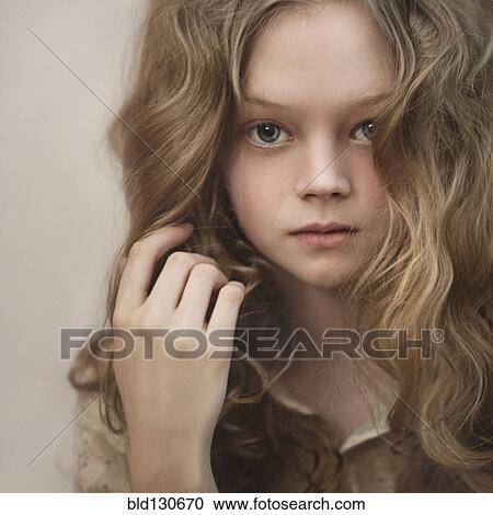 Stock Image - Caucasian girl playing with her hair. Fotosearch
