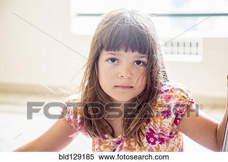 Stock Photography - Caucasian girl sitting indoors. Fotosearch