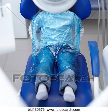 Caucasian girl wearing plastic sheet at dentist View Large Photo Image Stock Photograph - Caucasian girl wearing plastic sheet at dentist. Fotosearch