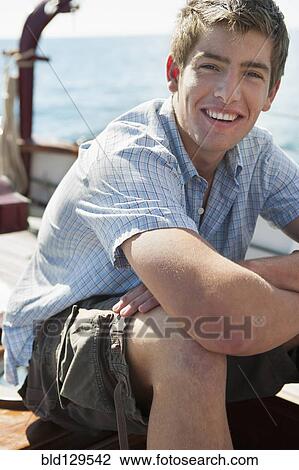 Caucasian man relaxing on sailboat View Large Photo Image Stock Image - Caucasian man relaxing on sailboat. Fotosearch