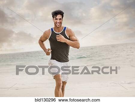 Caucasian man running on beach View Large Photo Image Stock Photograph - Caucasian man running on beach. Fotosearch