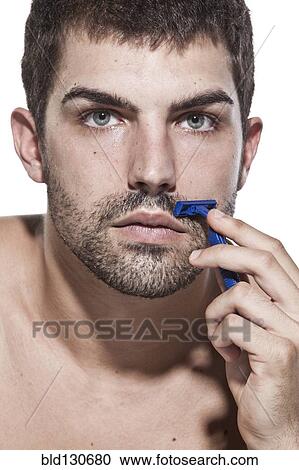 Caucasian man shaving his beard View Large Photo Image Stock Image - Caucasian man shaving his beard. Fotosearch