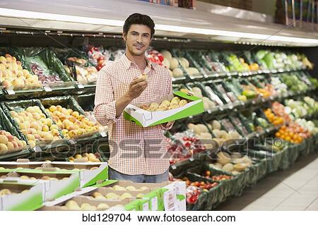 Caucasian man shopping in grocery store View Large Photo Image Picture - Caucasian man shopping in grocery store. Fotosearch