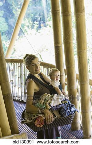 Caucasian mother and baby with basket of laundry View Large Photo Image Stock Image - Caucasian mother and baby with basket of laundry. Fotosearch