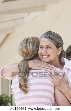 Caucasian mother and daughter hugging View Large Photo Image Stock Image - Caucasian mother and daughter hugging. Fotosearch