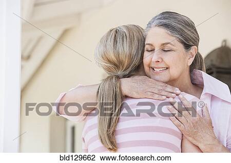 Caucasian mother and daughter hugging View Large Photo Image Stock Image - Caucasian mother and daughter hugging. Fotosearch