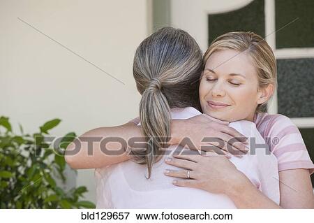 Stock Photo - Caucasian mother and daughter hugging. Fotosearch