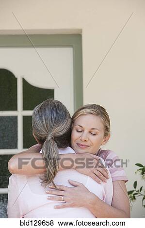 Caucasian mother and daughter hugging View Large Photo Image Stock Photo - Caucasian mother and daughter hugging. Fotosearch