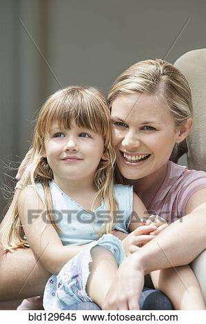 Stock Photography - Caucasian mother and daughter laughing outdoors. Fotosearch