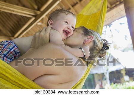 Caucasian mother holding baby in hammock View Large Photo Image Picture - Caucasian mother holding baby in hammock. Fotosearch