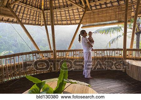 Caucasian mother holding baby on patio View Large Photo Image Stock Image - Caucasian mother holding baby on patio. Fotosearch