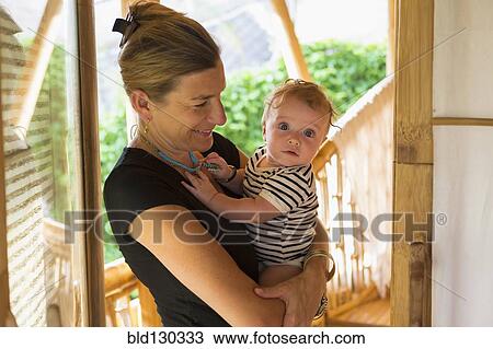 Caucasian mother holding baby View Large Photo Image Stock Image - Caucasian mother holding baby. Fotosearch